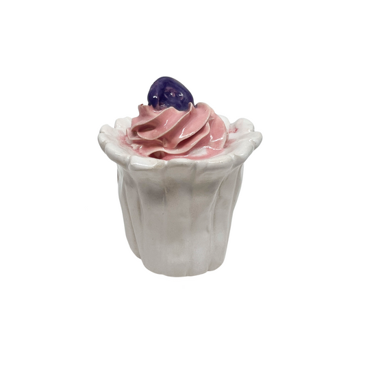 White Cupcake With Pink Frosting And Purple Medallion